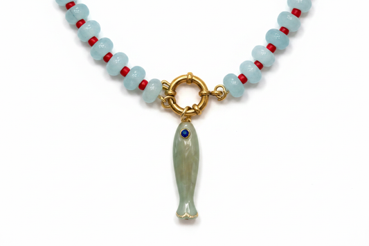 Close-up of gold clasp and light green fish charm
