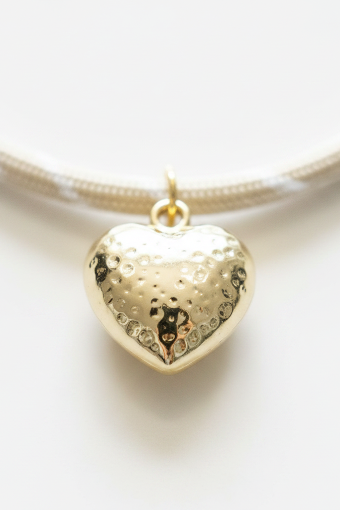 Puffy gold heart charm closeup