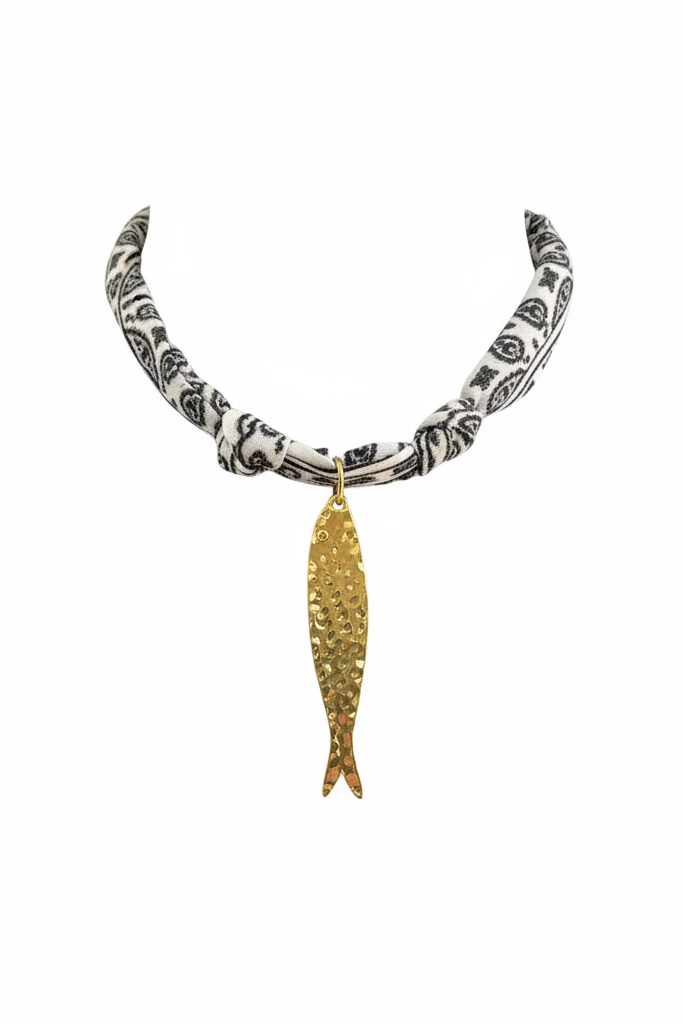 Gold fish charm necklace on black and white paisley bandana